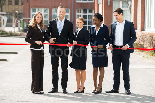Businesspeople Cutting Ribbon Stock photo © AndreyPopov