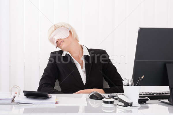 Businesswoman Wearing Eye Mask And Sleeping Stock photo © AndreyPopov