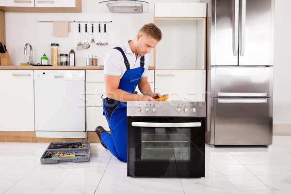 Technician Checking Oven With Digital Multimeter Stock photo © AndreyPopov