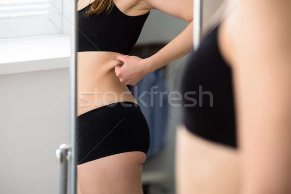 Woman Pinching Belly Skin Stock photo © AndreyPopov