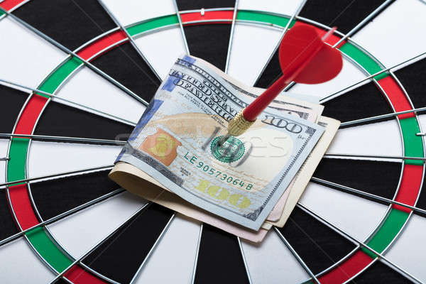 Arrow In Papernotes On Dartboard At Table Stock photo © AndreyPopov