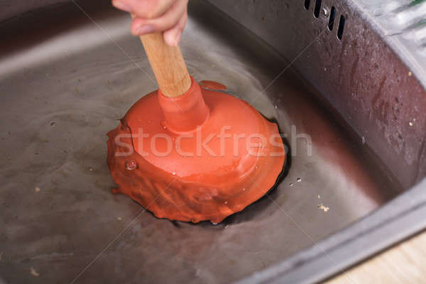 Person Cleaning Sink With Cup Plunger Stock photo © AndreyPopov