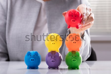 Person Placing Last Piece Into Pie Chart With Piggy Bank Stock photo © AndreyPopov