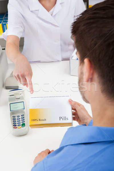 Pharmacist Showing Drug To Client Stock photo © AndreyPopov