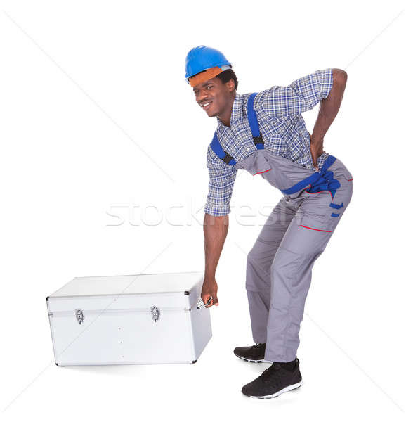 Man With Back Pain Lifting Metal Box Stock photo © AndreyPopov