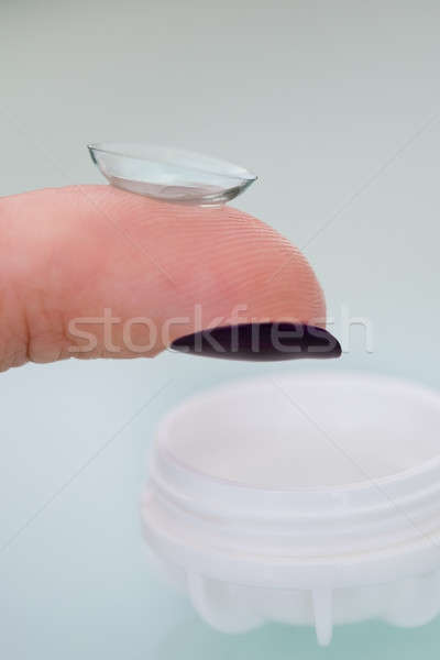Female finger with a contact lens on it Stock photo © AndreyPopov