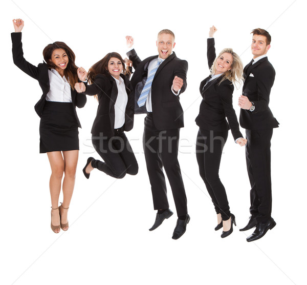 Successful Welldressed Businesspeople With Arms Raised Stock photo © AndreyPopov