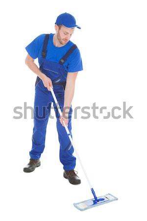 Confident Cleaner Mopping Over White Background Stock photo © AndreyPopov