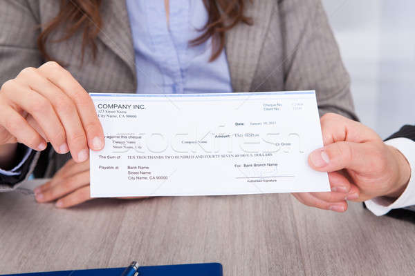 Businesspeople Holding Cheque Stock photo © AndreyPopov