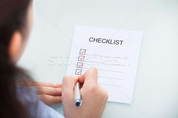 Businesswoman Marking On Checklist Stock photo © AndreyPopov