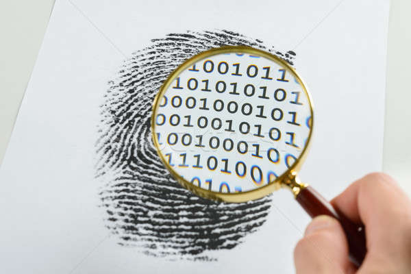 Hand With Magnifying Glass Over A Finger Print Stock photo © AndreyPopov