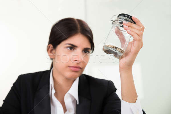 Businesswoman Holding Jar With Coins Stock photo © AndreyPopov