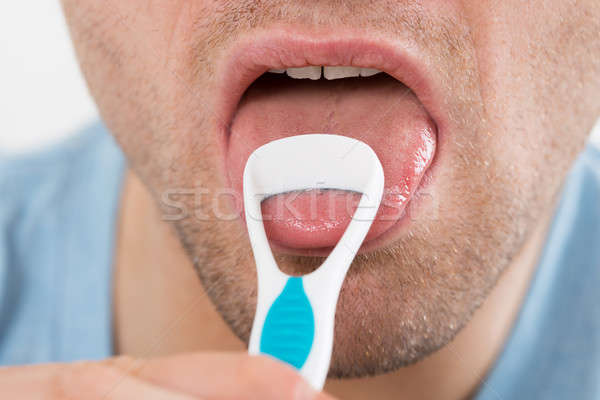 Man Cleaning His Tongue With Scraper Stock photo © AndreyPopov