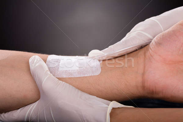 Doctor Holding Patient's Hand With Iv Drip Stock photo © AndreyPopov