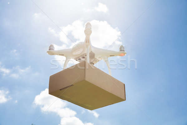 Drone delivering parcel against sky on sunny day Stock photo © AndreyPopov