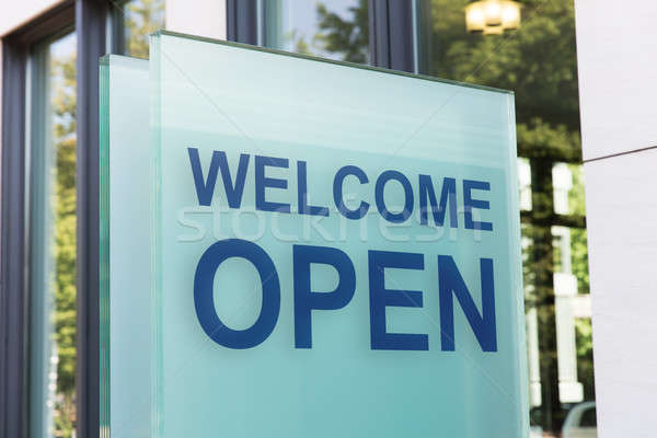Welcome open sign on glass board outside building in city Stock photo © AndreyPopov