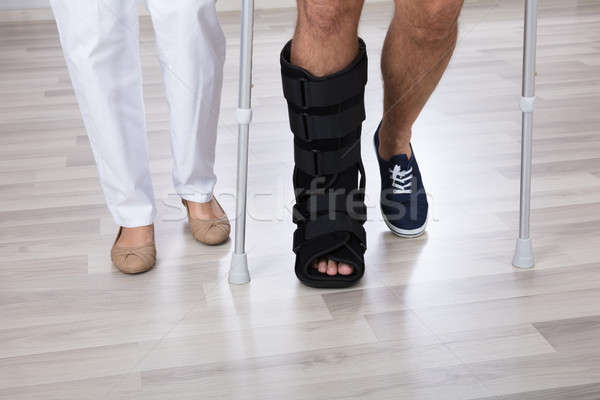 Low Section View Of Physiotherapist And Injured Person's Leg Stock photo © AndreyPopov