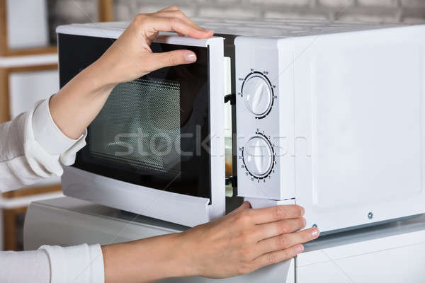 Woman's Hands Closing Microwave Oven Door And Preparing Food Stock photo © AndreyPopov