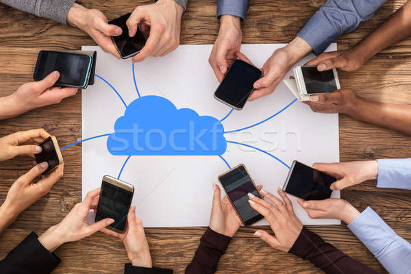Mensen mobiele telefoons wolk communicatie netwerk Stockfoto © AndreyPopov