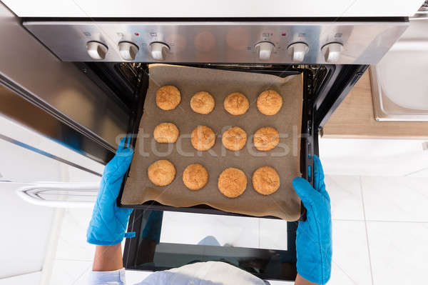 Taking Out Tray Of Baked Cookies From Oven Stock photo © AndreyPopov