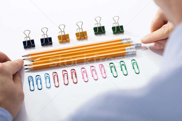 Businessman Arranging The Pencils In Between Colorful Pins Stock photo © AndreyPopov