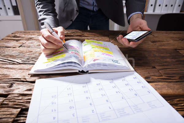 Businessperson Writing Schedule In Diary Stock photo © AndreyPopov