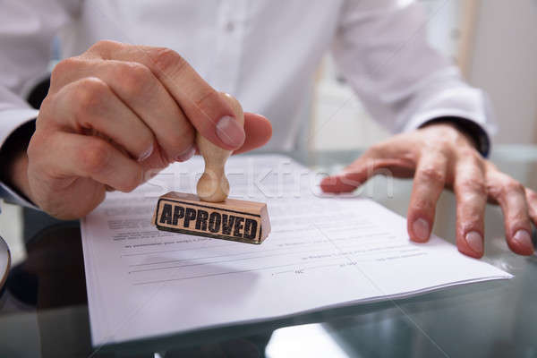 Businessman Stamping Approved On Contract Paper Stock photo © AndreyPopov