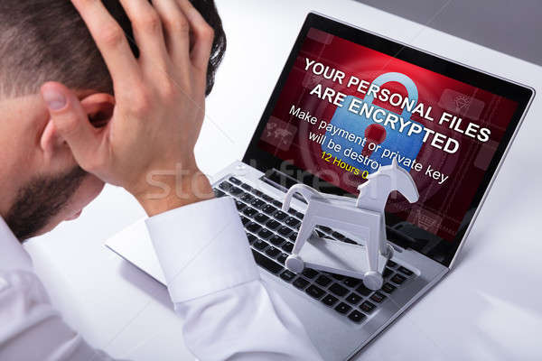 Businessman With Laptop Screen Showing Ransomware Message Stock photo © AndreyPopov