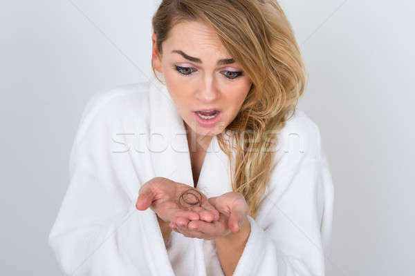 Worried Woman Holding Loss Hair Stock photo © AndreyPopov