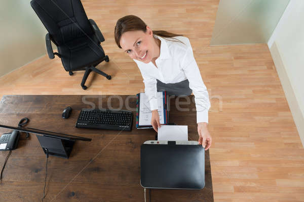 Young Businesswoman Using Printer In Office Stock photo © AndreyPopov
