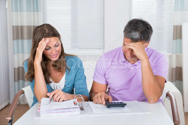 Worried Couple Looking At Unpaid Bills Stock photo © AndreyPopov