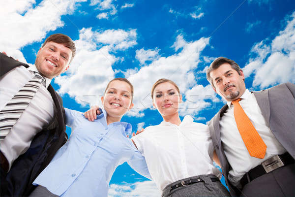 Confident Business Team Forming Huddle Against Sky Stock photo © AndreyPopov