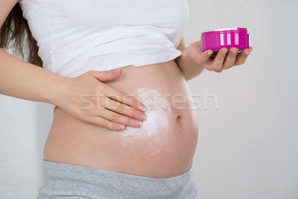 Pregnant Woman Applying Cream On Her Belly Stock photo © AndreyPopov