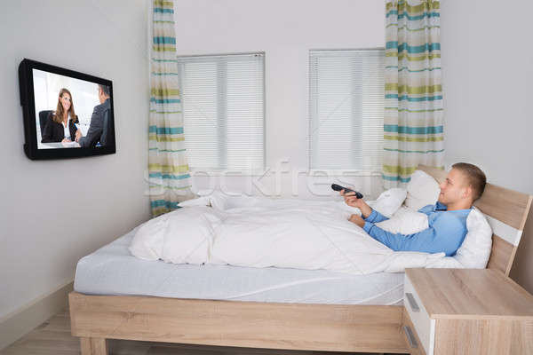 Man Holding Remote While Watching Television Stock photo © AndreyPopov
