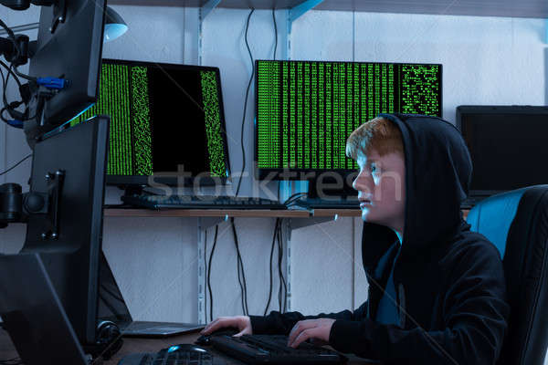 Boy Stealing Information From Multiple Computers Stock photo © AndreyPopov