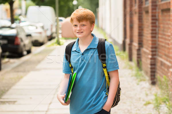 笑みを浮かべて 男子生徒 立って 歩道 肖像 フォルダ ストックフォト © AndreyPopov