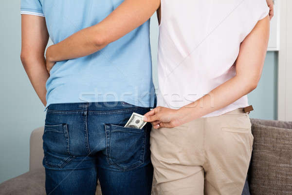 Woman Stealing Money From Husband's Pocket Stock photo © AndreyPopov