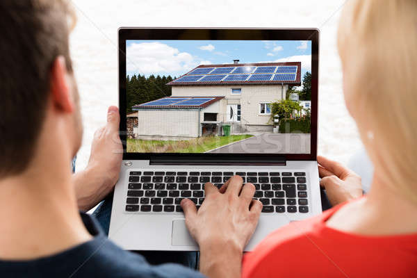 Couple Looking At House On Laptop Stock photo © AndreyPopov