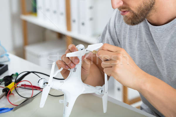 Stock photo: Male Hands Fixing Drone Propeller With Screw Driver