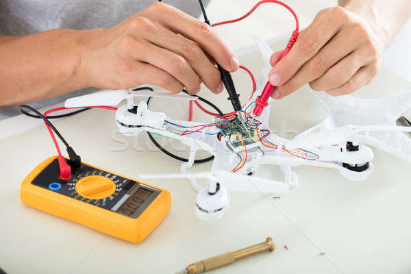 Man Testing Electric Current Of Drone Using Multimeter Tool Stock photo © AndreyPopov