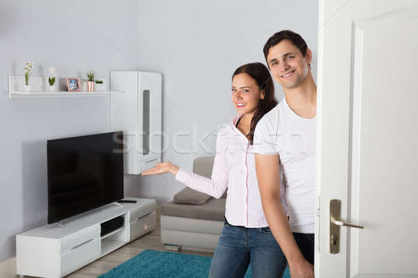 Couple Inviting People To Enter In Home Stock photo © AndreyPopov