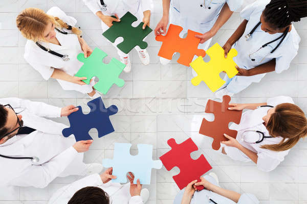 Group Of Doctors Holding Colorful Puzzle Stock photo © AndreyPopov