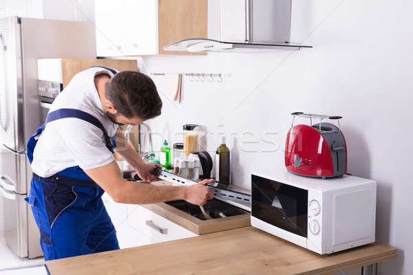 Electrician Repairing Induction Stove Stock photo © AndreyPopov