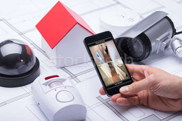 Architect Using Home Security System On Mobile Phone Stock photo © AndreyPopov