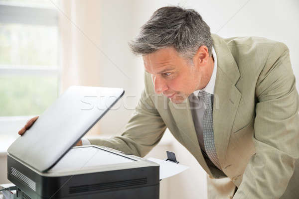 Businessman Looking At Photocopy Machine Stock photo © AndreyPopov