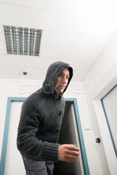 Man In Hoodie Walking Under Cctv Surveillance Area Stock photo © AndreyPopov