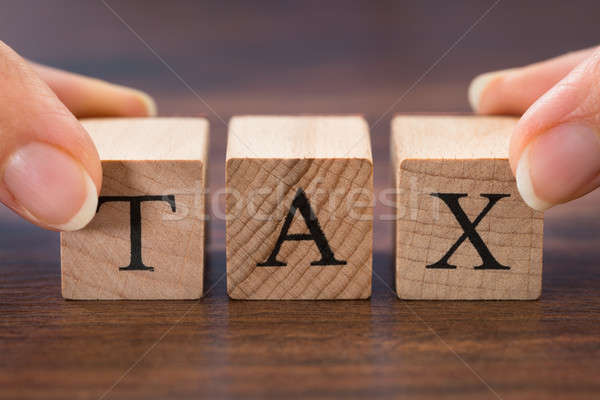 Person Hand Holding The Word Tax Stock photo © AndreyPopov