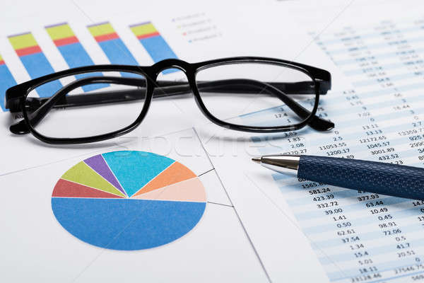 Financial Data Sheet With Eyeglasses And Pen Stock photo © AndreyPopov