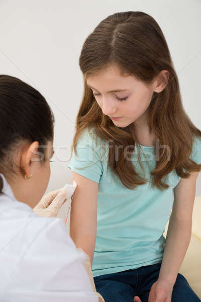 Doctor Injecting Syringe To Patient Stock photo © AndreyPopov
