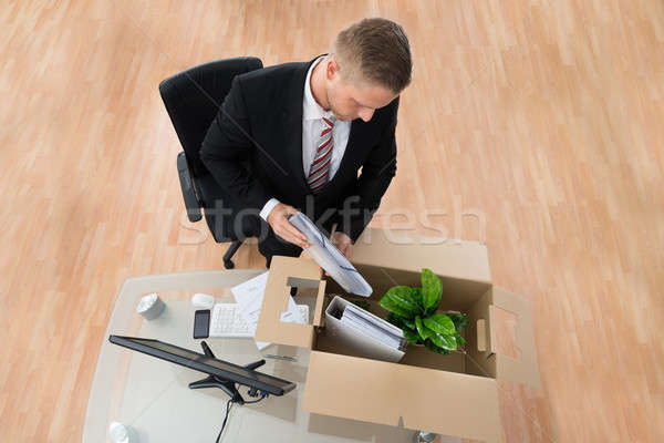 Businessman Packing Belongings In Cardboard Box Stock photo © AndreyPopov